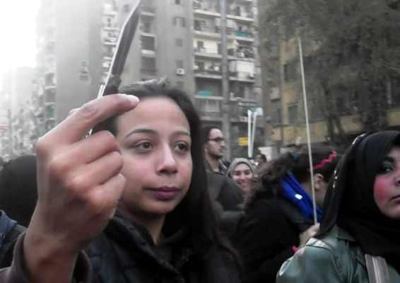 Women march carrying blades on anti-harassment protest