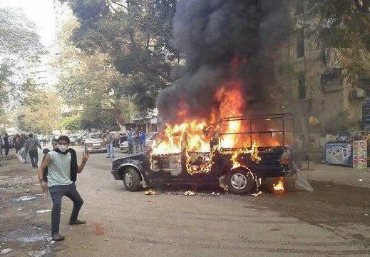Brotherhood supporters protest, torch police vehicle in Cairo district